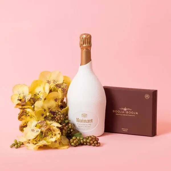A Moyses Stevens bouquet presented with a bottle of champagne